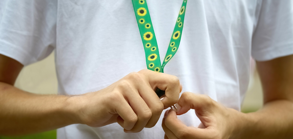 Close up of a child wearing a hidden disabilities sunflower lanyard