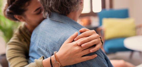 A girl and her mum embrace